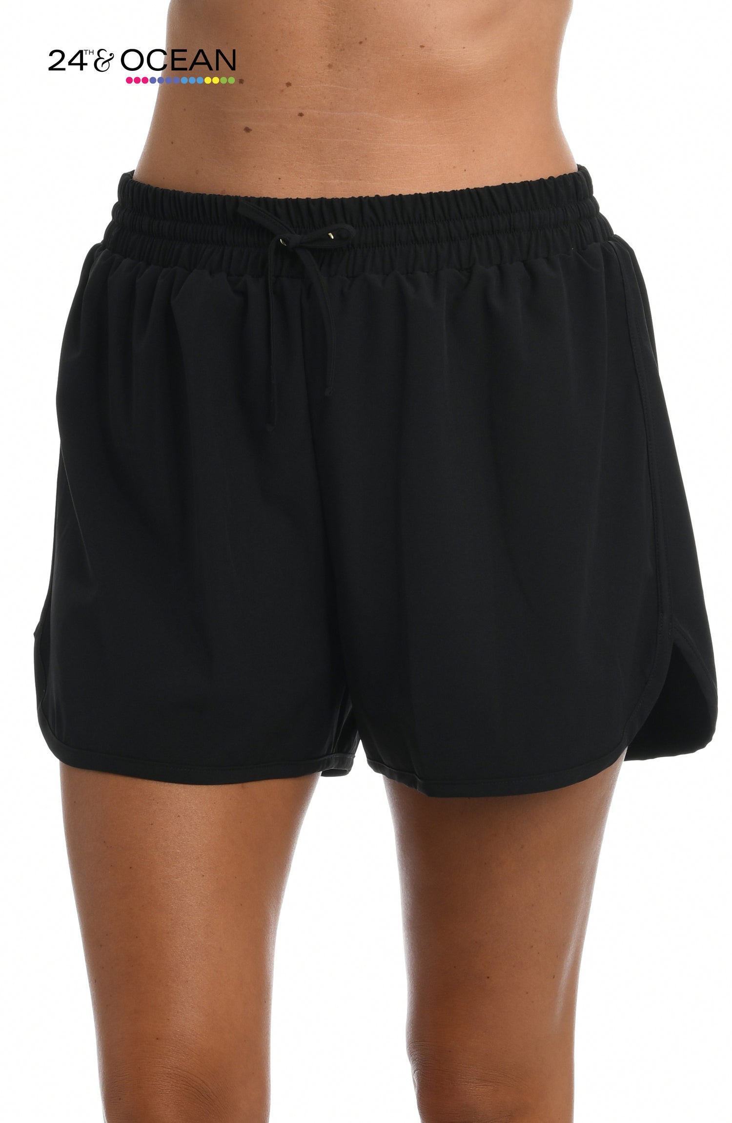 Model is wearing a solid black colored woven board short from our 24th & Ocean brand.