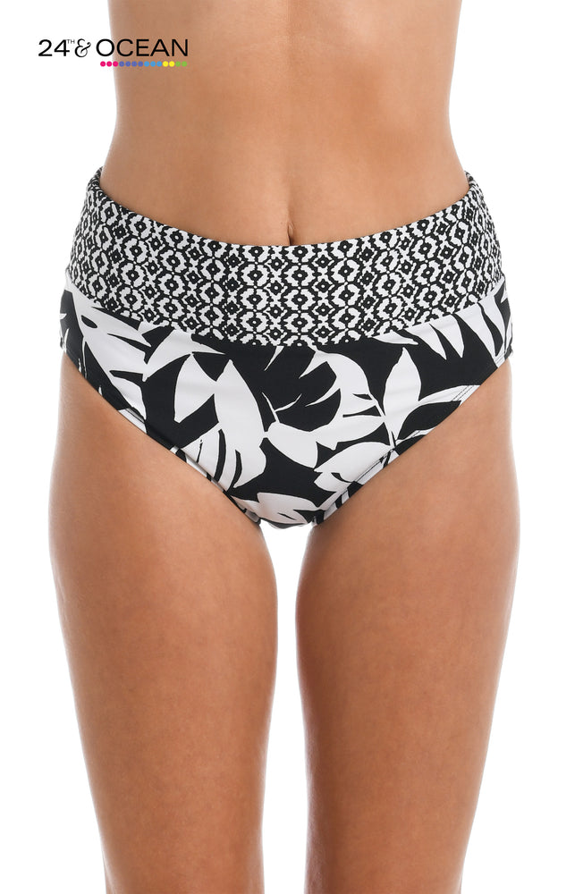 Model is wearing black and white multi colored tropical printed high waist bottom from our Antigua Leaf collection!