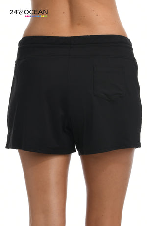 
            
                Load image into Gallery viewer, Model is wearing a solid black colored swim short bottom from our 24th &amp;amp; Ocean brand.
            
        