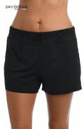 Model is wearing a solid black colored swim short bottom from our 24th & Ocean brand.