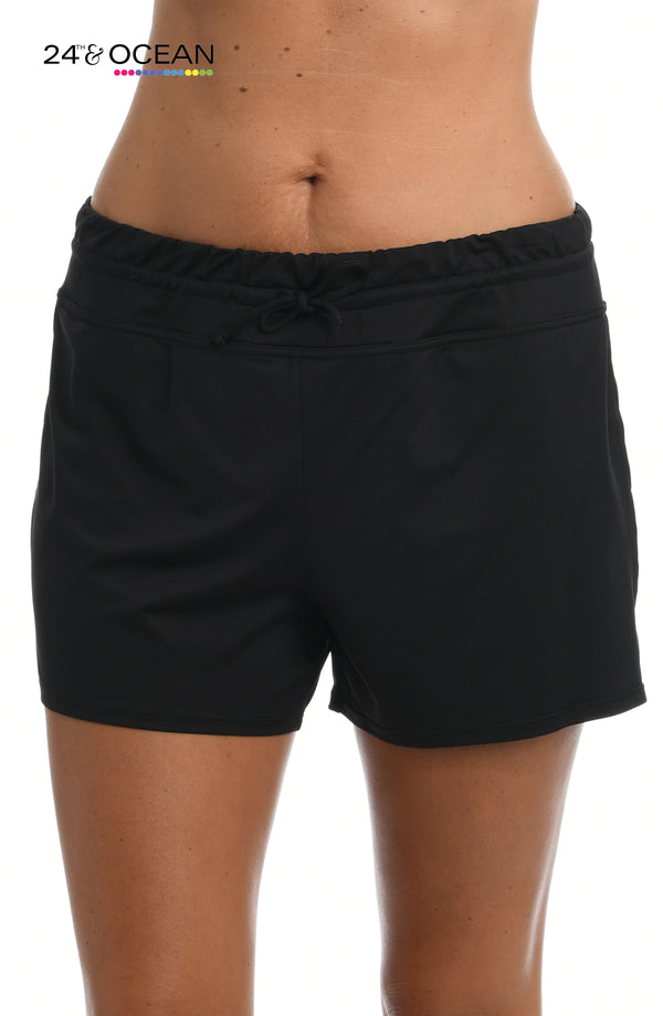 Model is wearing a solid black colored swim short bottom from our 24th & Ocean brand.