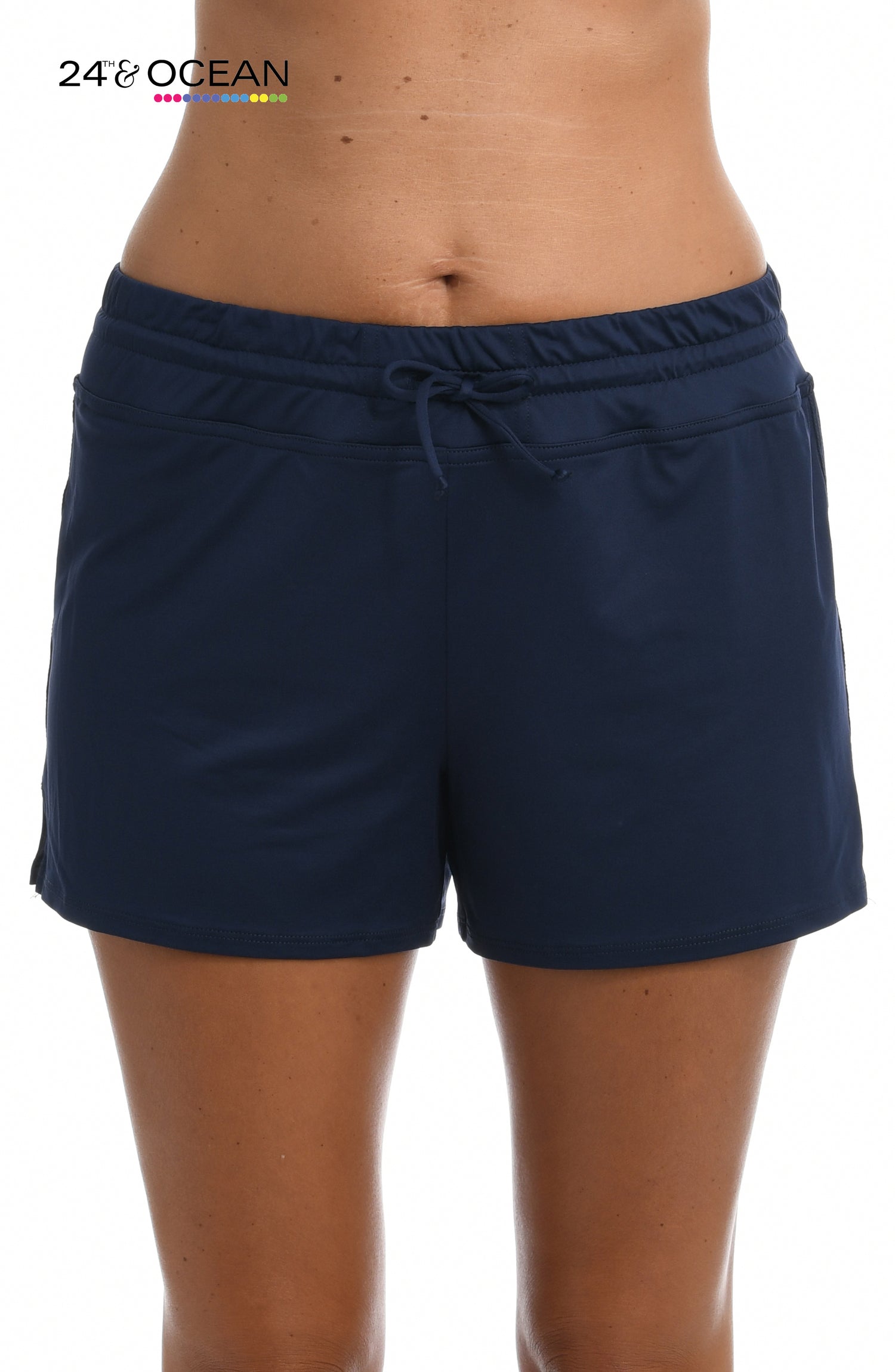 Model is wearing a solid midnight blue colored swim short bottom from our 24th & Ocean brand.