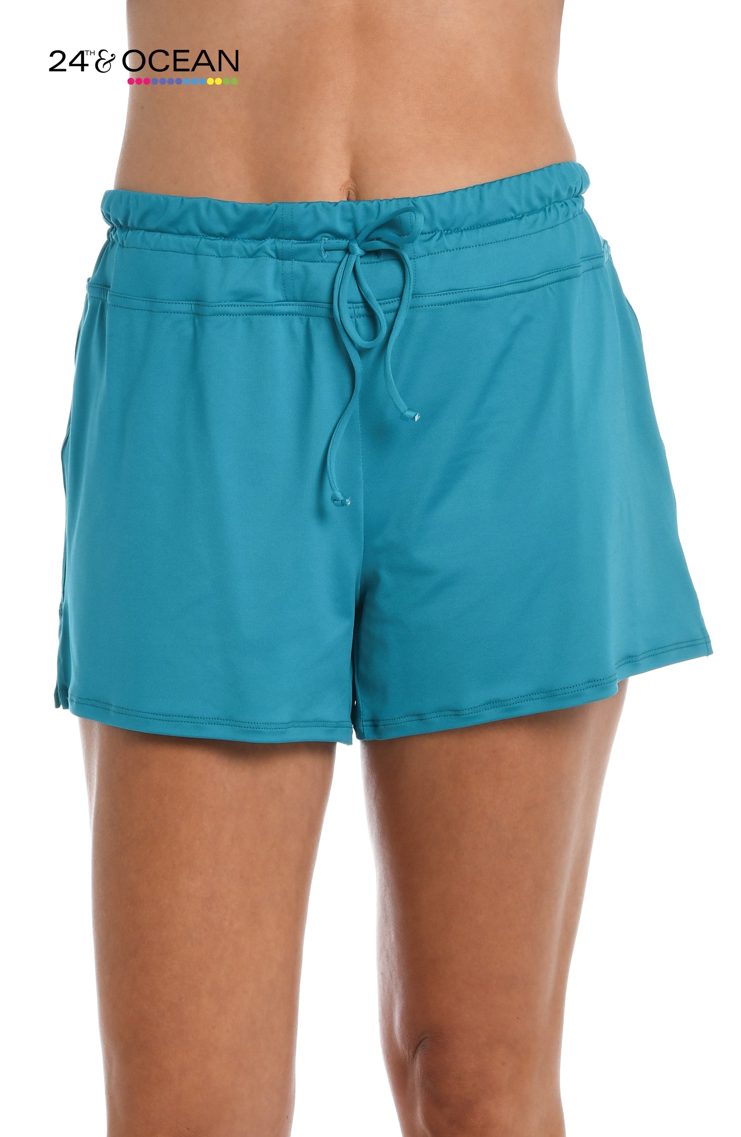 Model is wearing a solid teal colored swim short bottom from our 24th & Ocean brand.