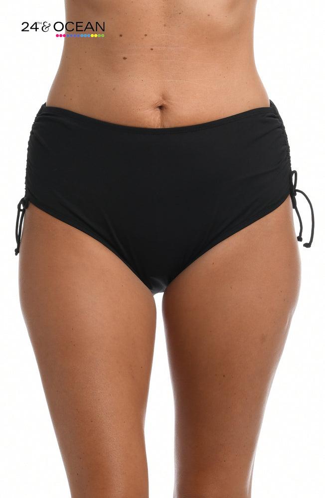 Model is wearing a solid black colored mid waist adjustable hipster bikini bottom from our 24th & Ocean brand.