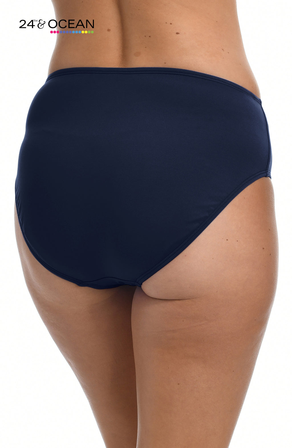 Model is wearing a solid midnight blue colored mid waist hipster bikini bottom from our 24th & Ocean brand.