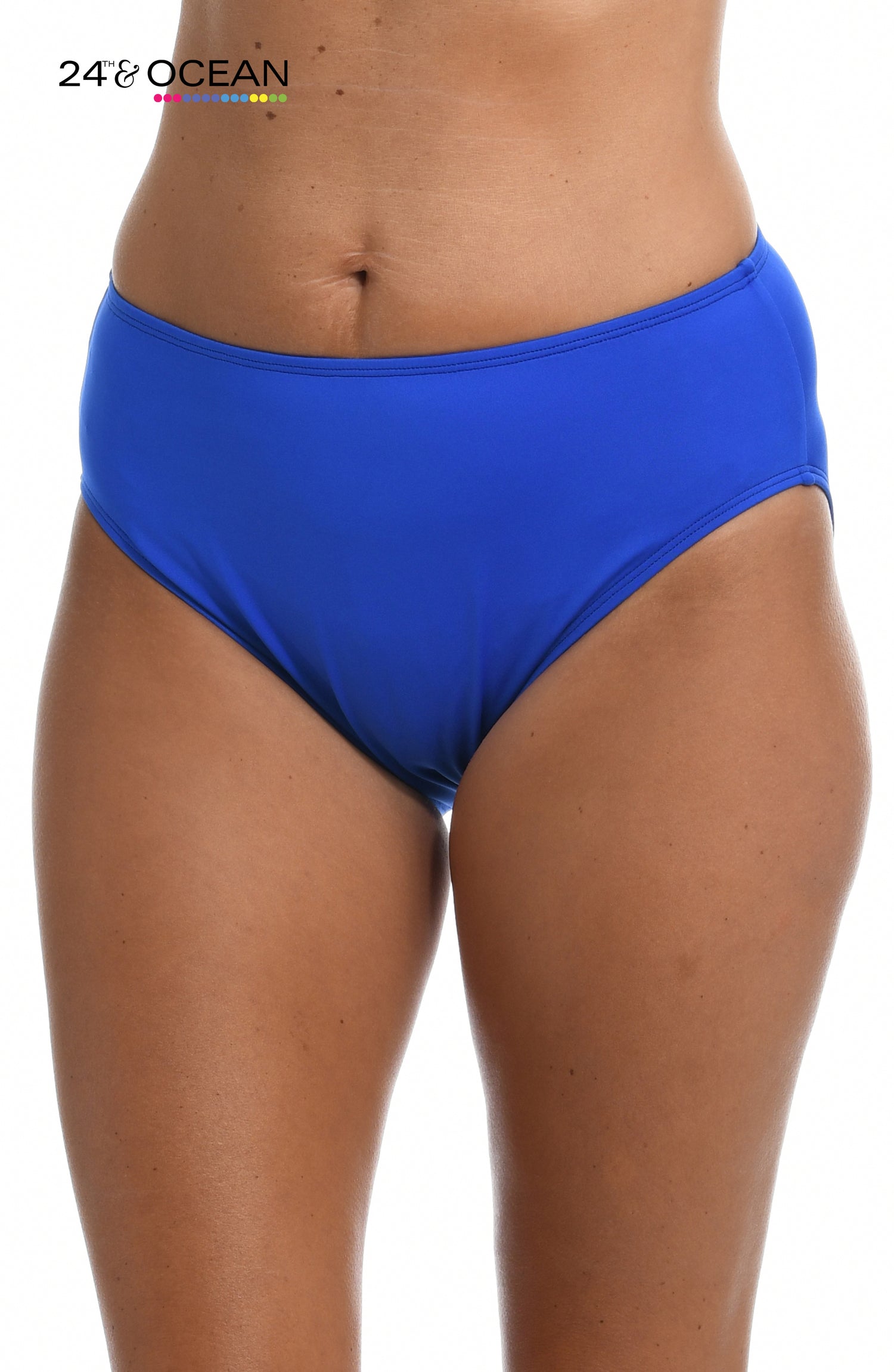 Model is wearing a solid sapphire blue colored mid waist hipster bikini bottom from our 24th & Ocean brand.