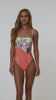 This is a video of a Model is wearing a coral multicolored floral printed bandeau one piece from our Sunshine 79 brand.