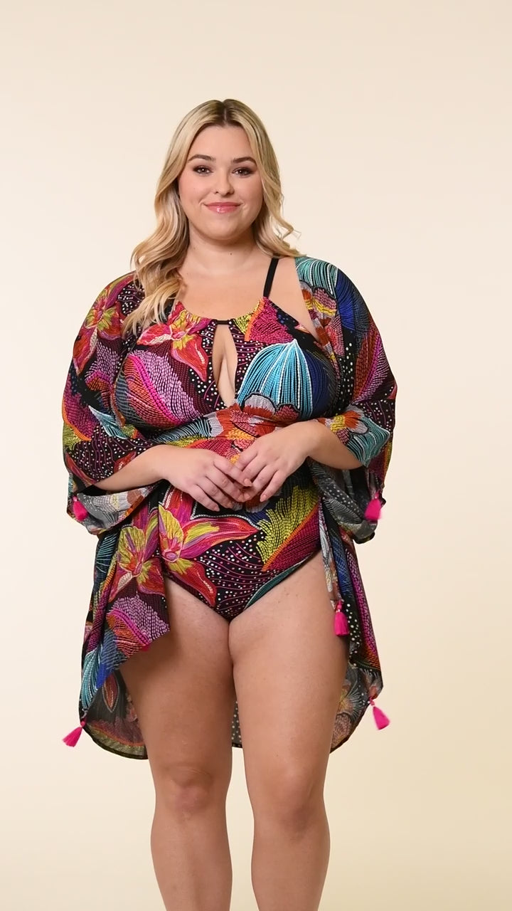 This is a video of a Model is wearing a shiny multicolored tropical printed kimono cover up from our Sunlit Soriee collection!