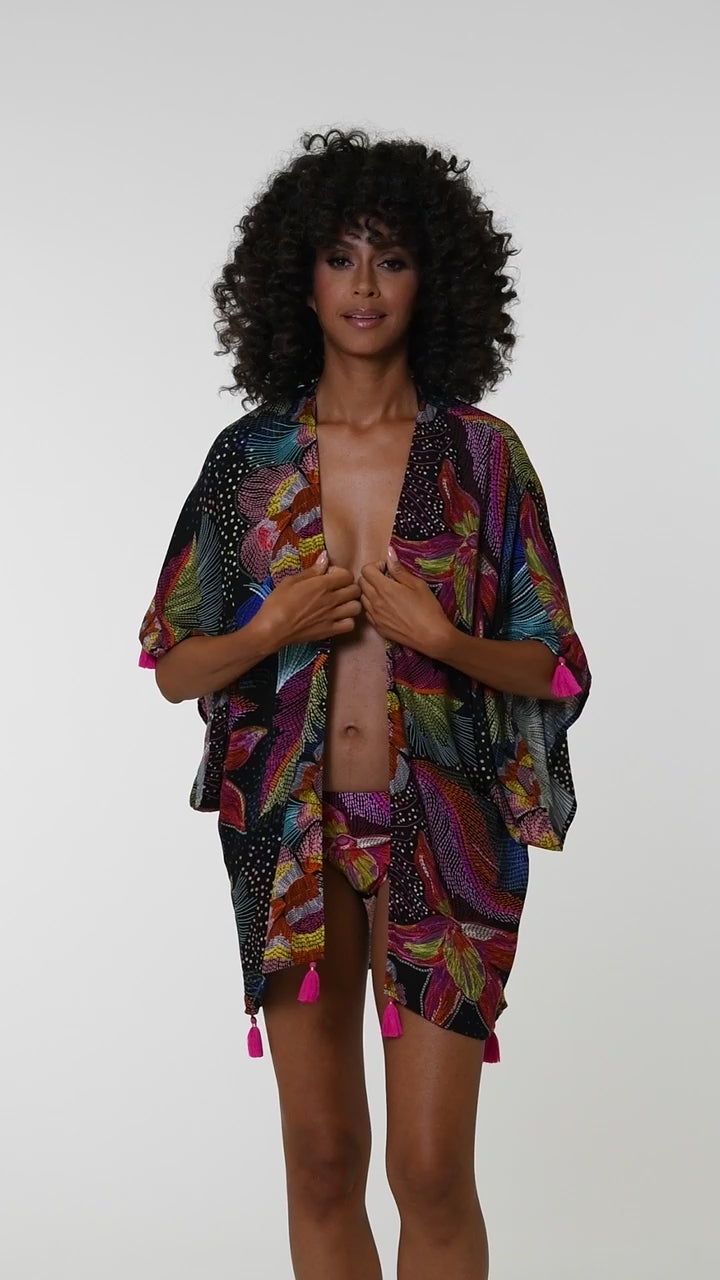 This is a video of a Model is wearing a shiny multicolored tropical printed halter top from our Sunlit Soriee collection!