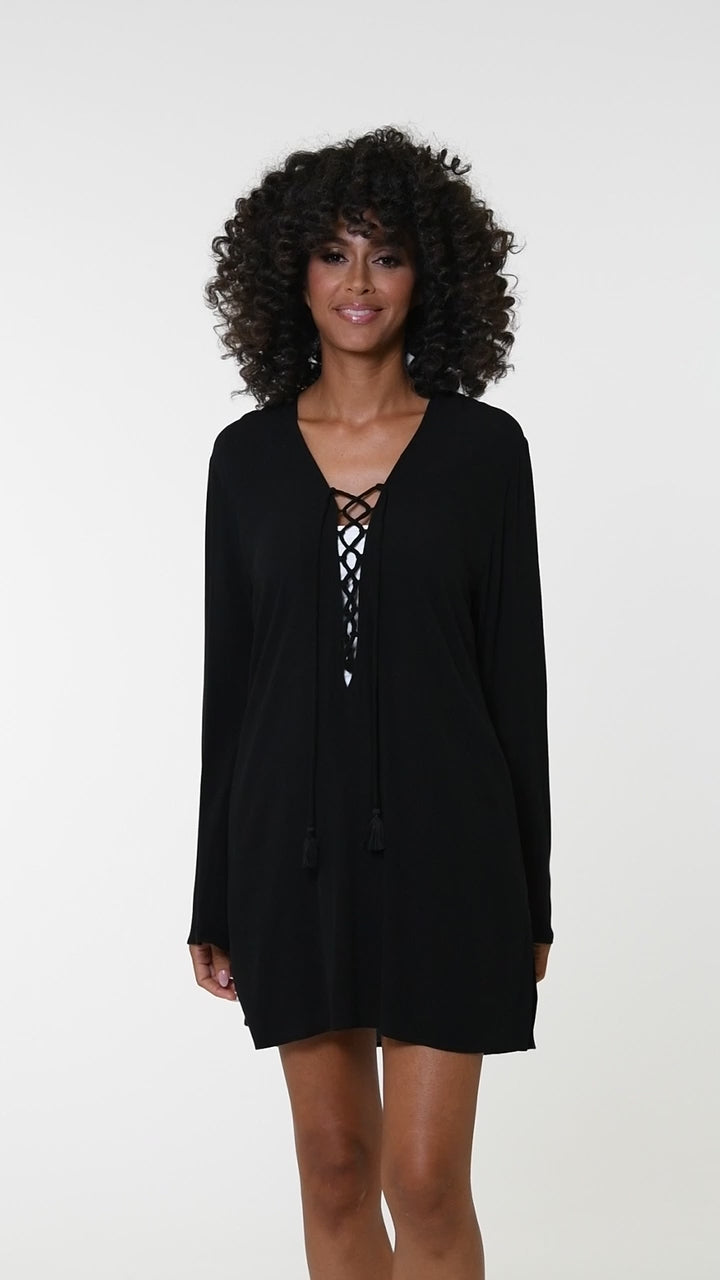 This is a video of a Model is wearing a solid black v-neck tunic over up from our Beachcomber Basics collection!